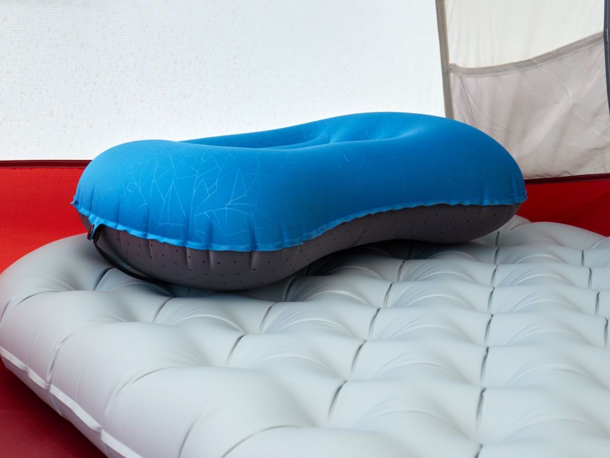 An inflatable pillow on a sleeping pad inside a tent — a roomy sleep setup